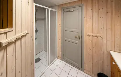 a bathroom with a walk in shower and a door at Pet Friendly Home In Hovden I Setesdal in Hovden
