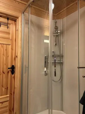 a shower with a glass door in a bathroom at Cozy cabin in Eikedalen in Eikedalen