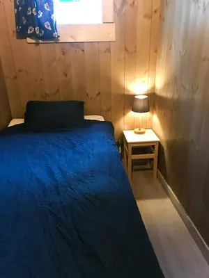 a bedroom with a bed and a lamp on a table at Private Cabin With Stunning Views Near Oslo in Eina