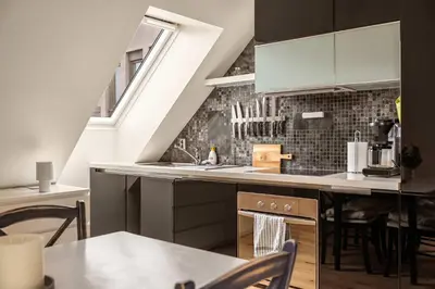 a kitchen with a sink and a counter top at DINBNB Apartments l 200m to Bryggen l Luxury 2 BR l 2min to Floibanen in Bergen