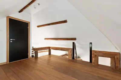 a room with two wooden benches and a black door at DINBNB Apartments l 200m to Bryggen l Luxury 2 BR l 2min to Floibanen in Bergen
