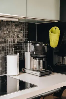 a kitchen with a counter with pots and pans at DINBNB Apartments l 200m to Bryggen l Luxury 2 BR l 2min to Floibanen in Bergen