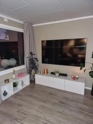 a living room with a large flat screen tv at Modern semi-detached house with free parking in Lillehammer