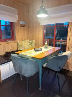 a kitchen with a blue table and two chairs at Adventurous cabin cozy on Sjusjøen with sauna! in Sjusjøen