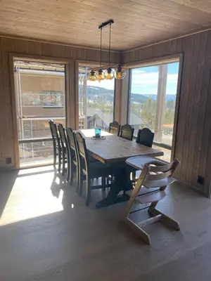 a dining room with a wooden table and chairs at Cabin at Norefjell! Perfect for families with children in Runn