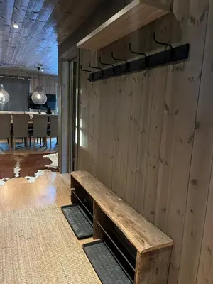 a wooden wall with a bench in a dining room at Modern mountain apartmen Ski in and out in Trysil