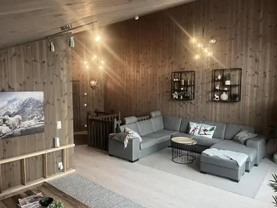a living room with a couch and a table at Modern mountain apartmen Ski in and out in Trysil