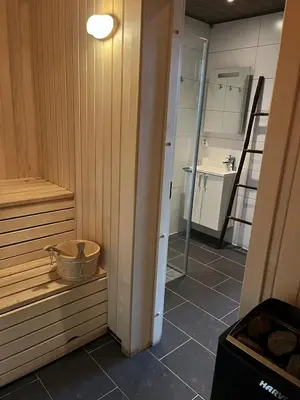 a room with a sauna with a basket on the floor at Modern mountain apartmen Ski in and out in Trysil