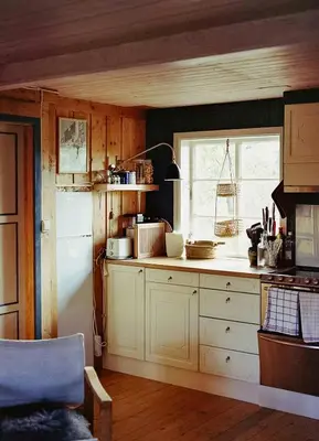 a kitchen with white cabinets and a white refrigerator at Cozy Cabin In Scenic Vøringsfoss in Garden