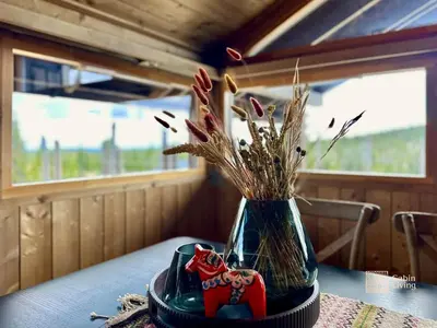 a vase with flowers in it sitting on a table at Modern mountain cabin Ski in-out 2 Bathrooms in Ringsaker