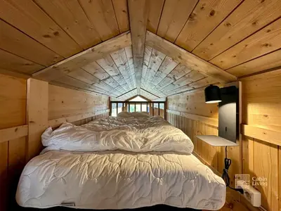 a bed in a room with a wooden ceiling at Modern mountain cabin Ski in-out 2 Bathrooms in Ringsaker