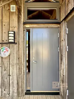 a door in a wooden building with a sign on it at Modern mountain cabin Ski in-out 2 Bathrooms in Ringsaker