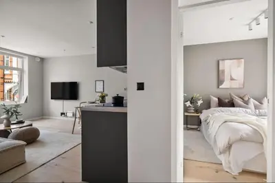 a bedroom with a bed and a living room at Rålekker 2-roms leilighet in Bergen