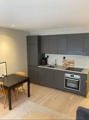 a kitchen with a table and a dining room at Rålekker 2-roms leilighet in Bergen