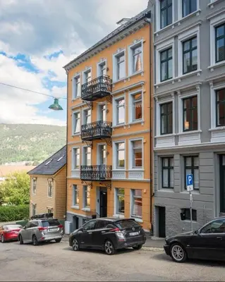 a group of cars parked in front of a building at Rålekker 2-roms leilighet in Bergen