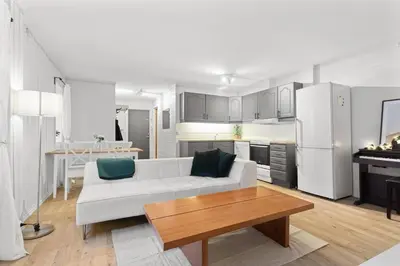a living room with a white couch and a table at Staymate apartments. Trondheim sentrum in Trondheim