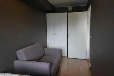 a living room with a couch and a closet at Staymate apartment at Lade in Trondheim