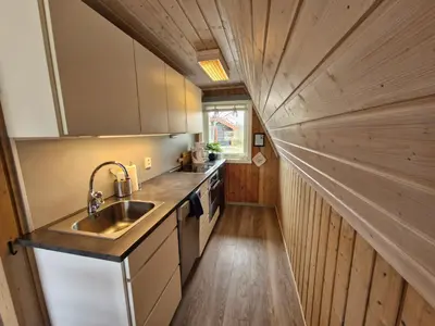 a small kitchen with a sink and a counter at Fjellhytte i Valdres, rett ved nasjonalpark og turstier in Robøle