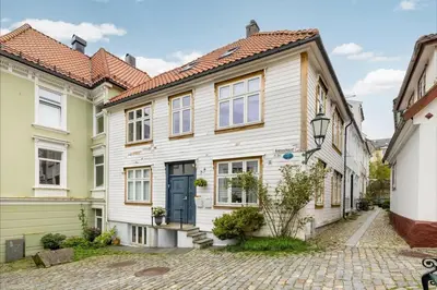 a house with a cobblestone street at Welcome to our home in the centre of Bergen! in Bergen