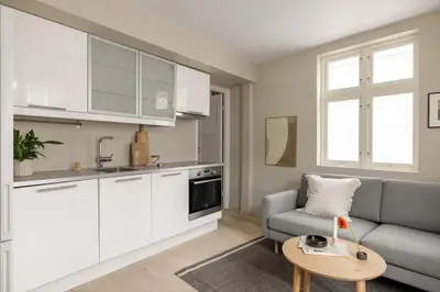 a kitchen and living room with a couch and a table at Welcome to our home in the centre of Bergen! in Bergen
