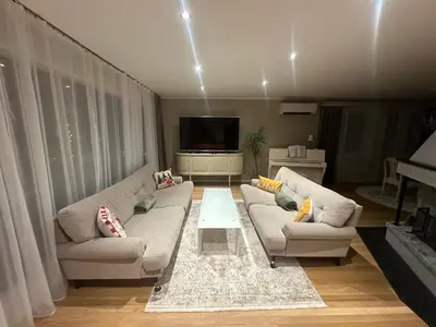 a living room with two couches and a tv at Magnhilds Luxury Apartment in Otta