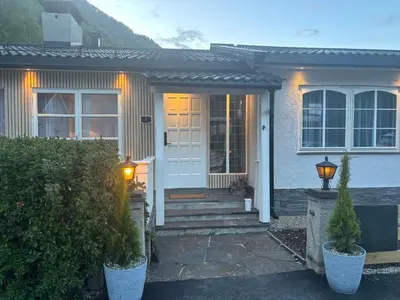 a house with a white door and a porch at Magnhilds Luxury Apartment in Otta