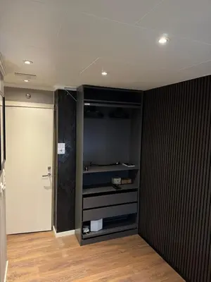 a room with a closet with a door and a room with at CozyStay Beside Historic Bryggen in Bergen