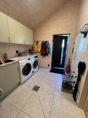 a kitchen with a washing machine in a room at Rinden cabin in Sogndal