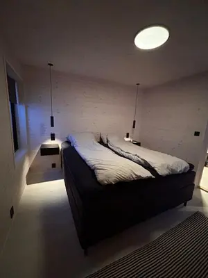 a bedroom with a bed with two lights on it at Rinden cabin in Sogndal