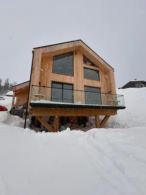 a wooden house in the snow in the snow at Rinden cabin in Sogndal
