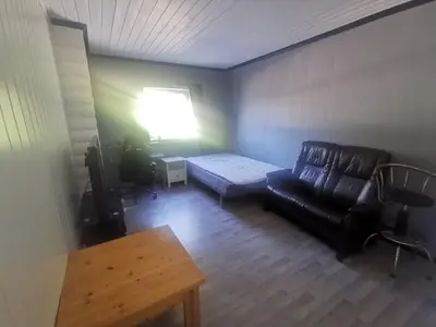 a living room with a couch and a table at Fjordgløtt in Blålia