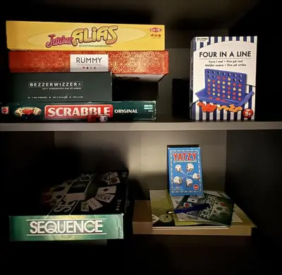 a shelf filled with games and board games at Dream cabin by Geilo, ski-in ski-out with room for the whole family in Geilo