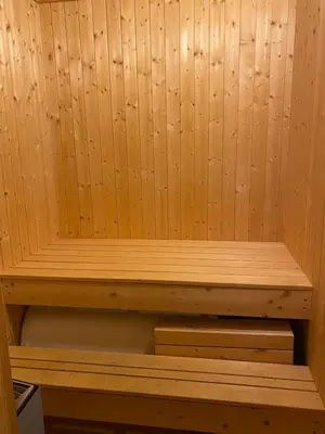 a wooden sauna with a wooden bench in it at Trollslottet på Skeikampen in Aulstad
