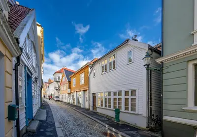 an empty street in a city with buildings at Newly renovated apartment in the heart of Bergen city center in Bergen