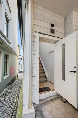 an open door of a building with a staircase at Newly renovated apartment in the heart of Bergen city center in Bergen