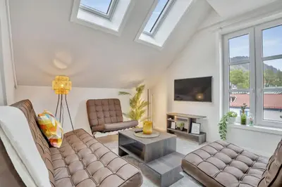a living room with a couch and a table at Heimby - Seaside Luxury - Free Parking in Bergen