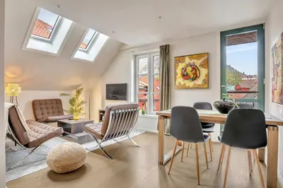 a living room with a table and chairs at Heimby - Seaside Luxury - Free Parking in Bergen