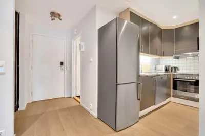 a kitchen with a stainless steel refrigerator at Heimby - Seaside Luxury - Free Parking in Bergen