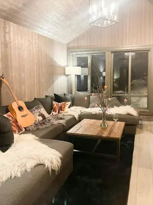 a living room with a couch and a guitar at Mountain Escape Near Gulsrud With Historical Charm in Eggedal