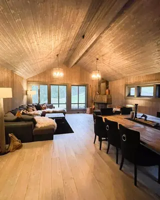 a large living room with a couch and a table at Mountain Escape Near Gulsrud With Historical Charm in Eggedal