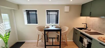 a small kitchen with a table and chairs in it at Morgensolen in Bergen