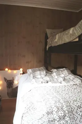 a bedroom with a bed with a cat on the wall at Ski-in ski-out high standard cabin, 3 bedroom in Oppdal