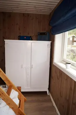 a small room with white cabinets and a window at Ski-in ski-out high standard cabin, 3 bedroom in Oppdal