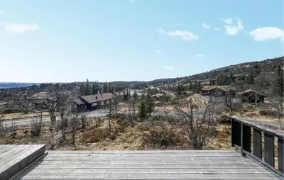 a wooden boardwalk with a view of a town at Stunning Home In Etnedal With Sauna in Etnedal