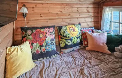 a couch with pillows on it in a room at Stunning Home In Etnedal With Sauna in Etnedal