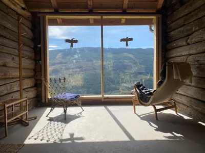 a room with a window with birds flying in the sky at Architect designed sleeping box in barn in Nos