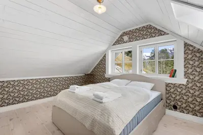 a bedroom with a bed and a window at Tømmerhuset på Brekketunet in Stryn