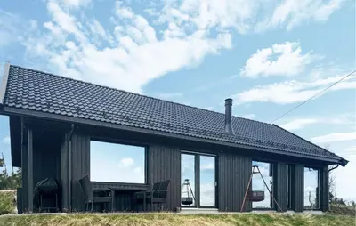 a house with large windows and a roof at Amazing Home In Løten in Løten