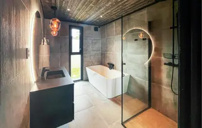 a bathroom with a sink and a shower at Amazing Home In Løten in Løten