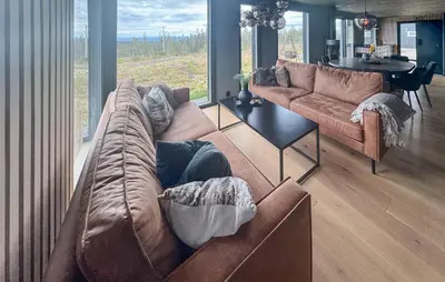 a living room with a brown couch and a table at Amazing Home In Løten in Løten